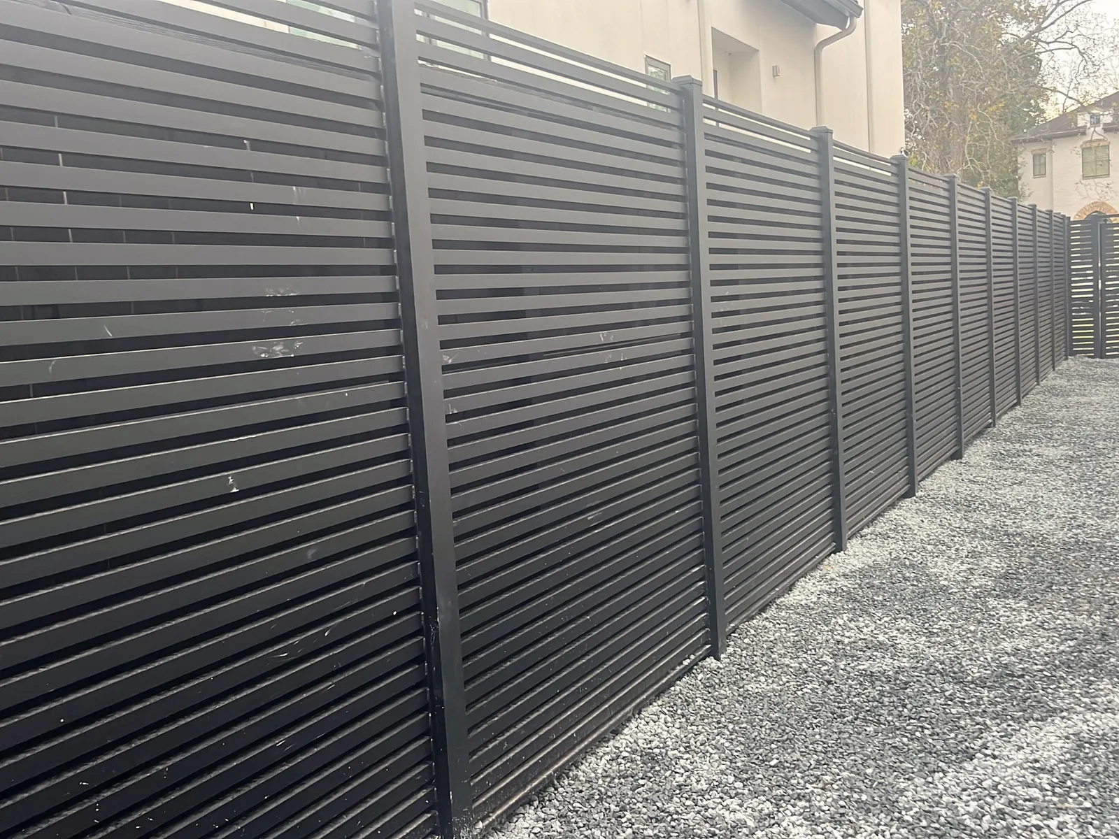 Modern horizontal metal privacy fence installed by Momiko